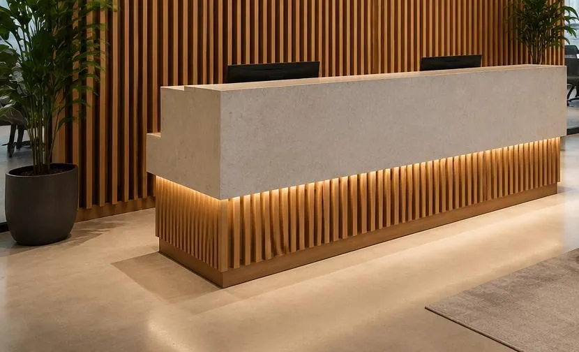 Office reception desk with a backlit timber slat base and slatted wall behind